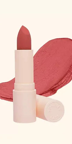 Lottiee Duty Organic Waterproof Matte Lipstick in a soft pink shade, shown in a tube with a smooth, matte finish. A swatch of the lipstick is visible beside the tube, showcasing its creamy texture.