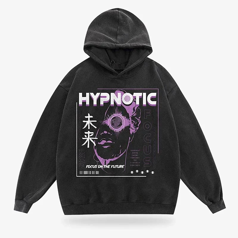 Black hoodie featuring a graphic print of a stylized face with spiral eye design and the text "HYPNOTIC FOCUS." Made from soft material, designed by Lottiee Duty, with a cozy hood and relaxed fit.