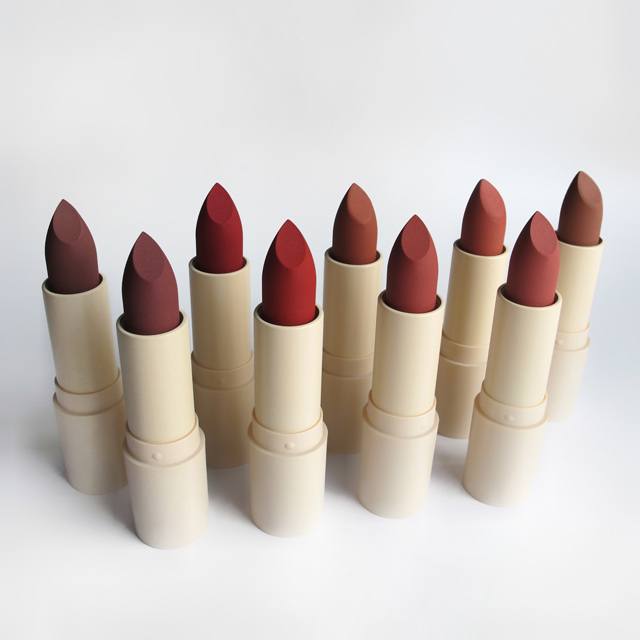 Lottiee Duty Organic Waterproof Matte Lipstick displayed in a row, featuring various shades of red and brown. Each lipstick has a sleek, beige cylindrical tube with a pointed tip, ideal for precise application.